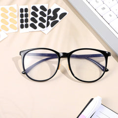 Close-up of black and skin-colored D-shaped nose pads for glasses