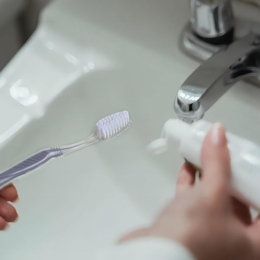 Grey medium toothbrush with soft bristles, individually wrapped