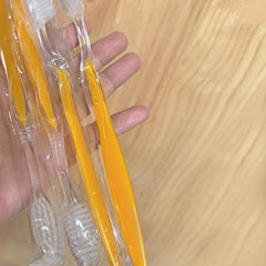 Bulk 100-pack toothbrushes arranged in a row