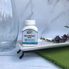 Tablets in bottle on white background