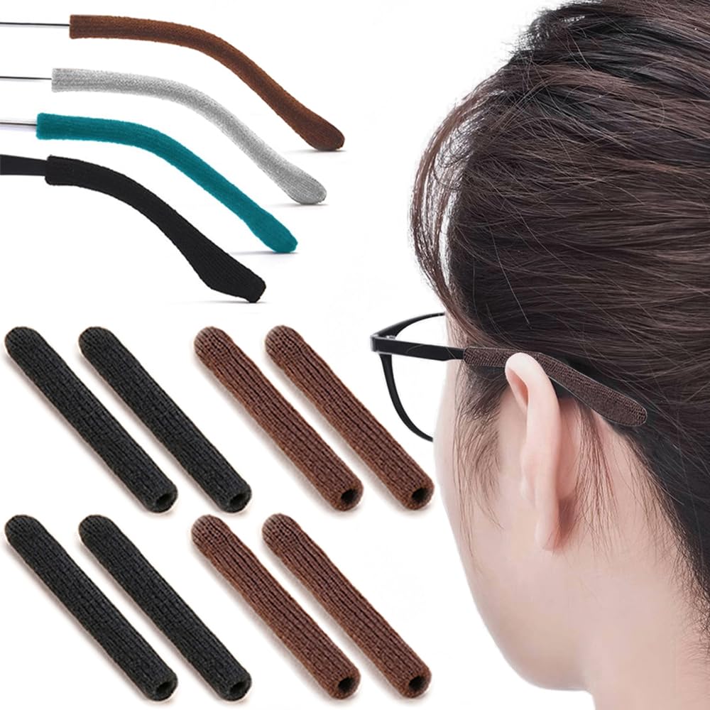 Four pairs of black and brown knitted eyeglasses ear grippers laid out