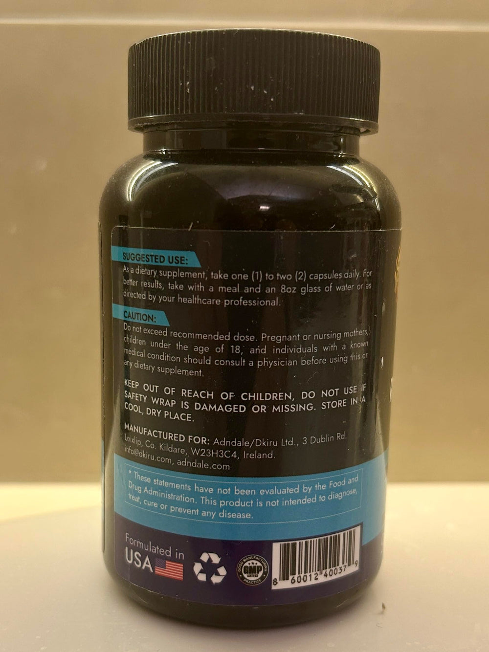 Two bottles of Adndale NAD+ Supplement on a desk