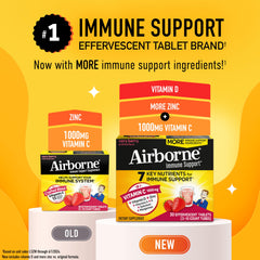 Airborne Very Berry effervescent tablet dissolving in a glass of water.