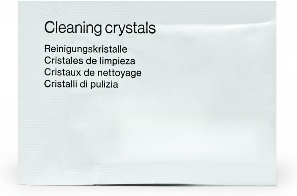 Clear aligners and retainers soaking in a cleaning dish