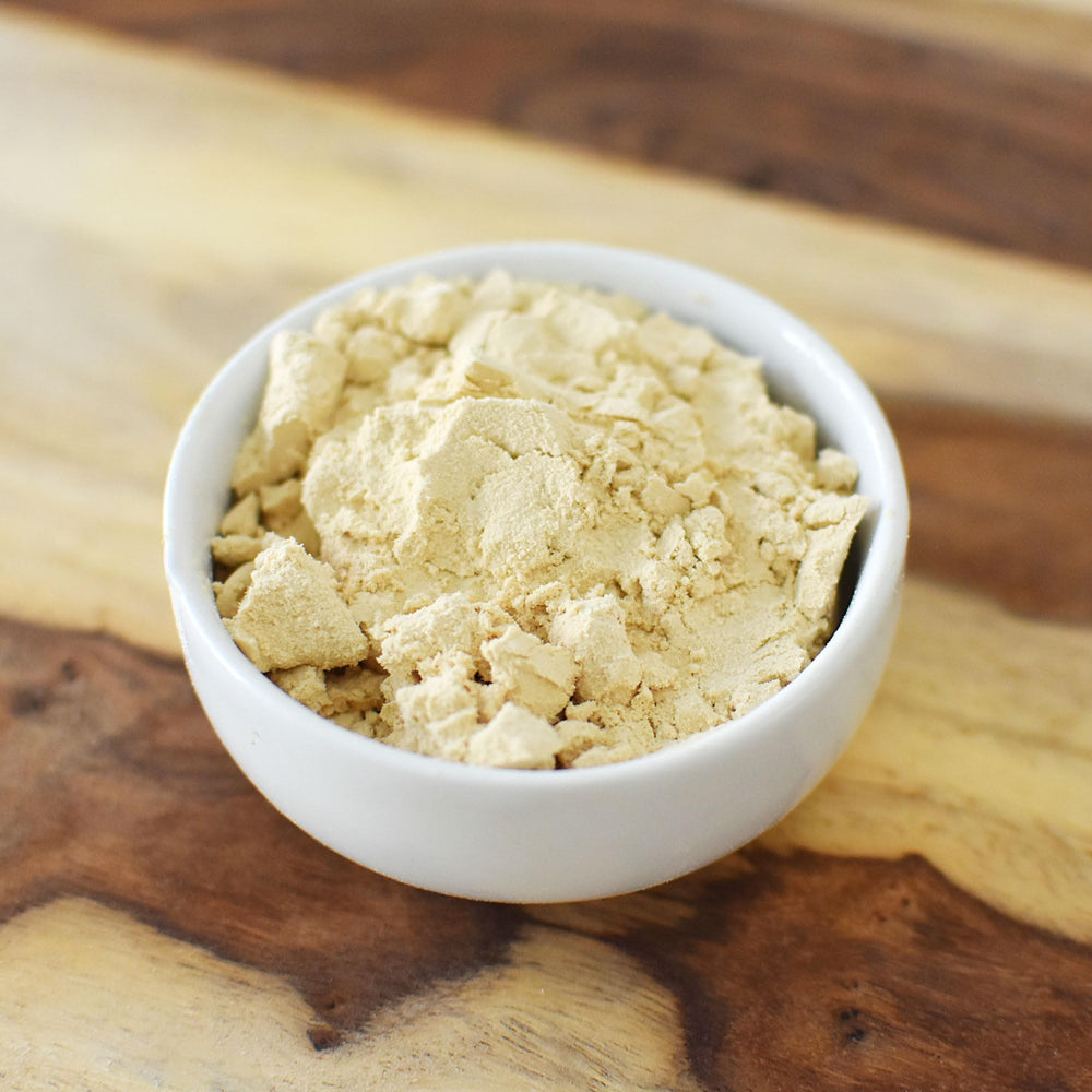 Unflavored and unsweetened pea protein powder in a measuring scoop