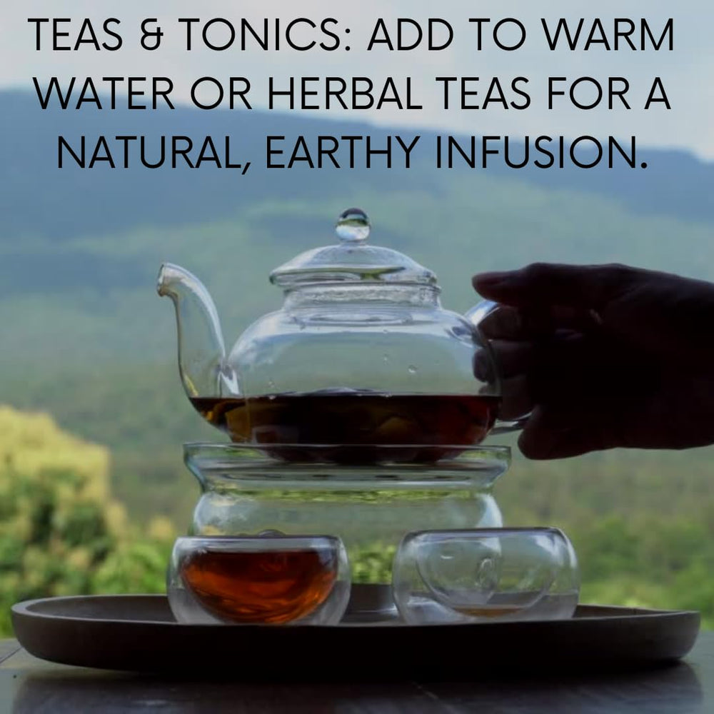 Leaves and ashoka bark powder beside a wooden scoop