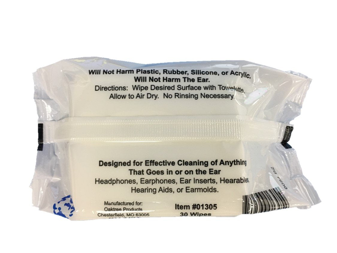 Close-up of a hearing aid being cleaned with an alcohol-free wipe