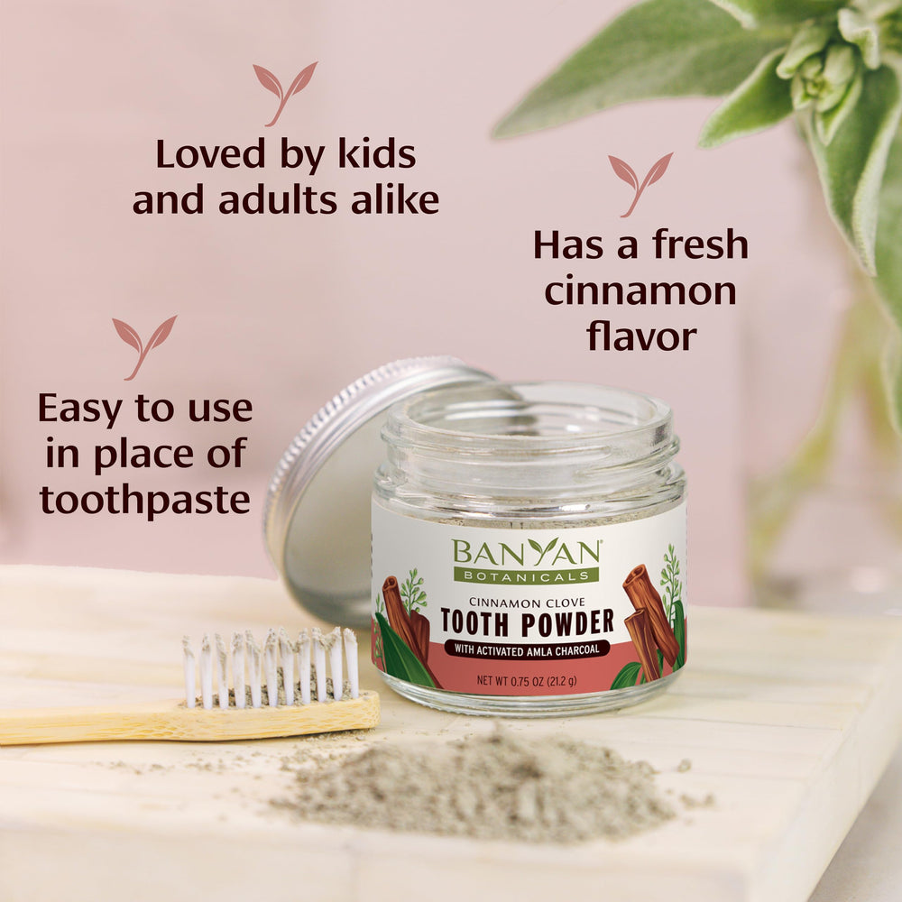 Scoop of Cinnamon Clove Tooth Powder on a white surface