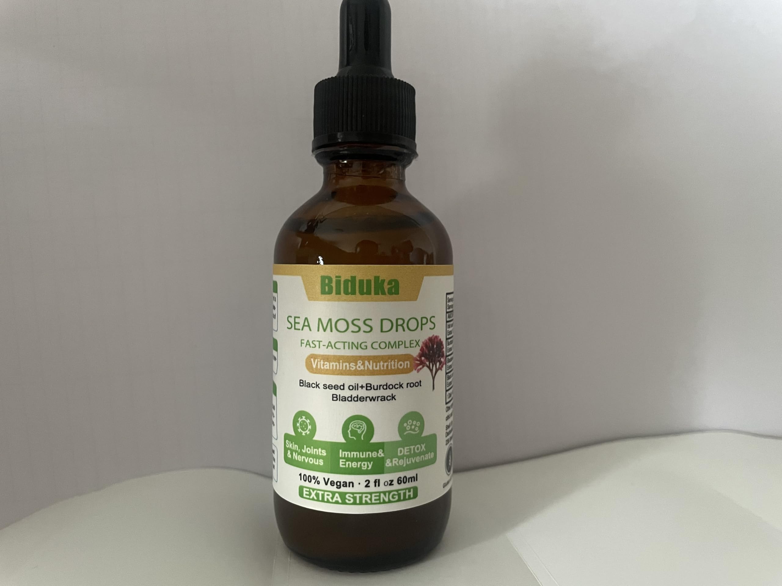 Black seed oil bottle with seeds