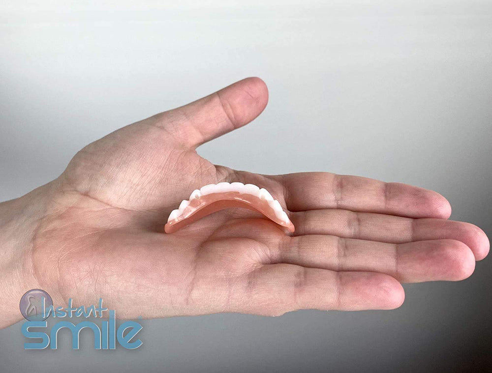 Temporary veneers being applied to bottom teeth
