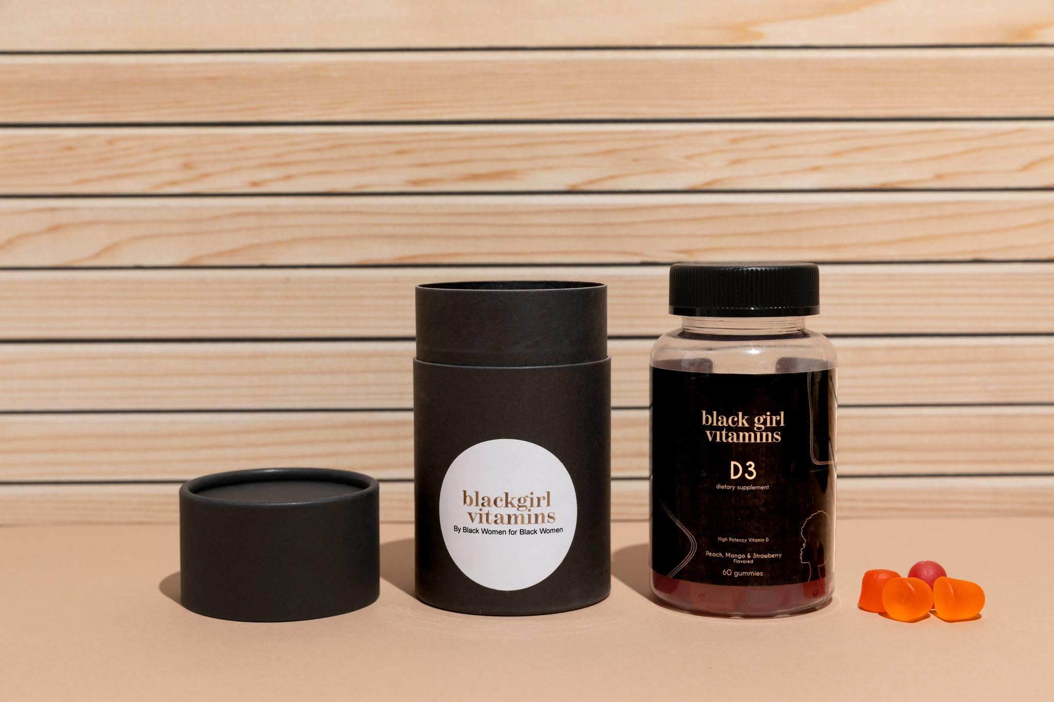 Lifestyle shot of a person taking Black Girl Vitamins D3 Gummies