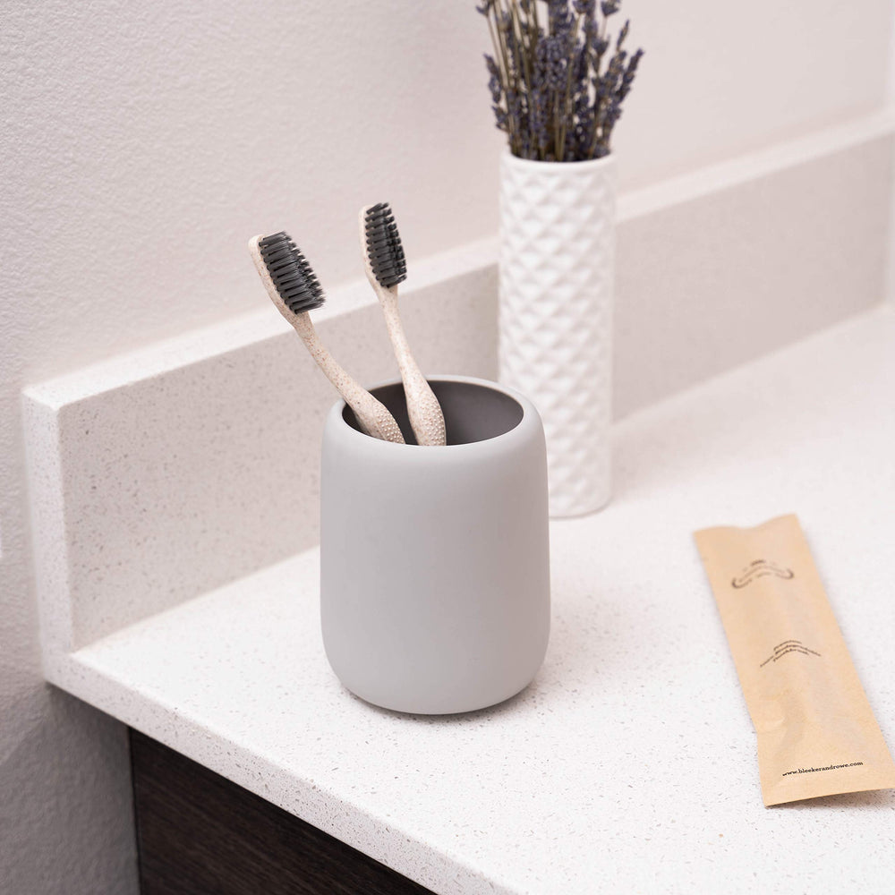 Toothbrush individually sealed in a recyclable paper sleeve