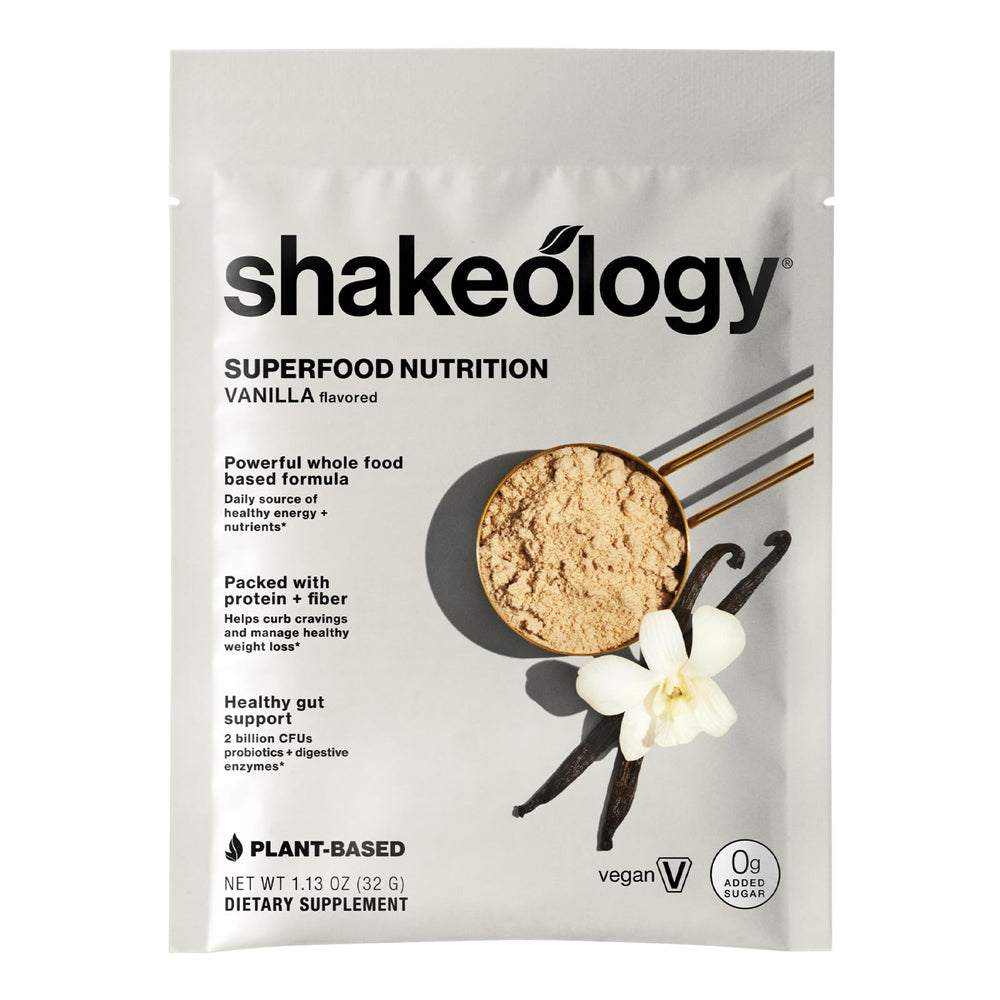 Travel-ready BODi Shakeology vanilla packet beside luggage for easy refuel