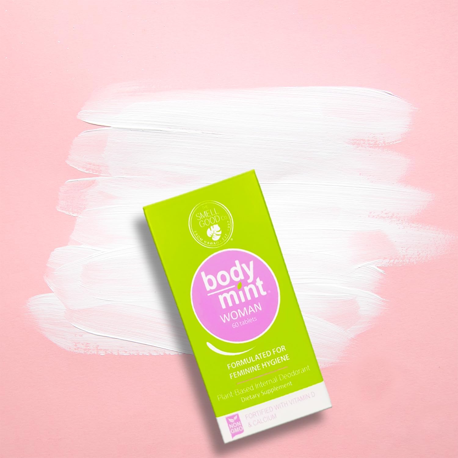 Close-up of Body Mint Woman bottle and green chlorophyll tablets
