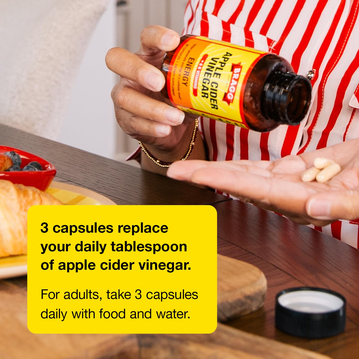 Bragg bottle beside apples to show product scale and natural focus