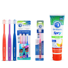Three Brilliant Kids toothbrushes in red, purple, and royal
