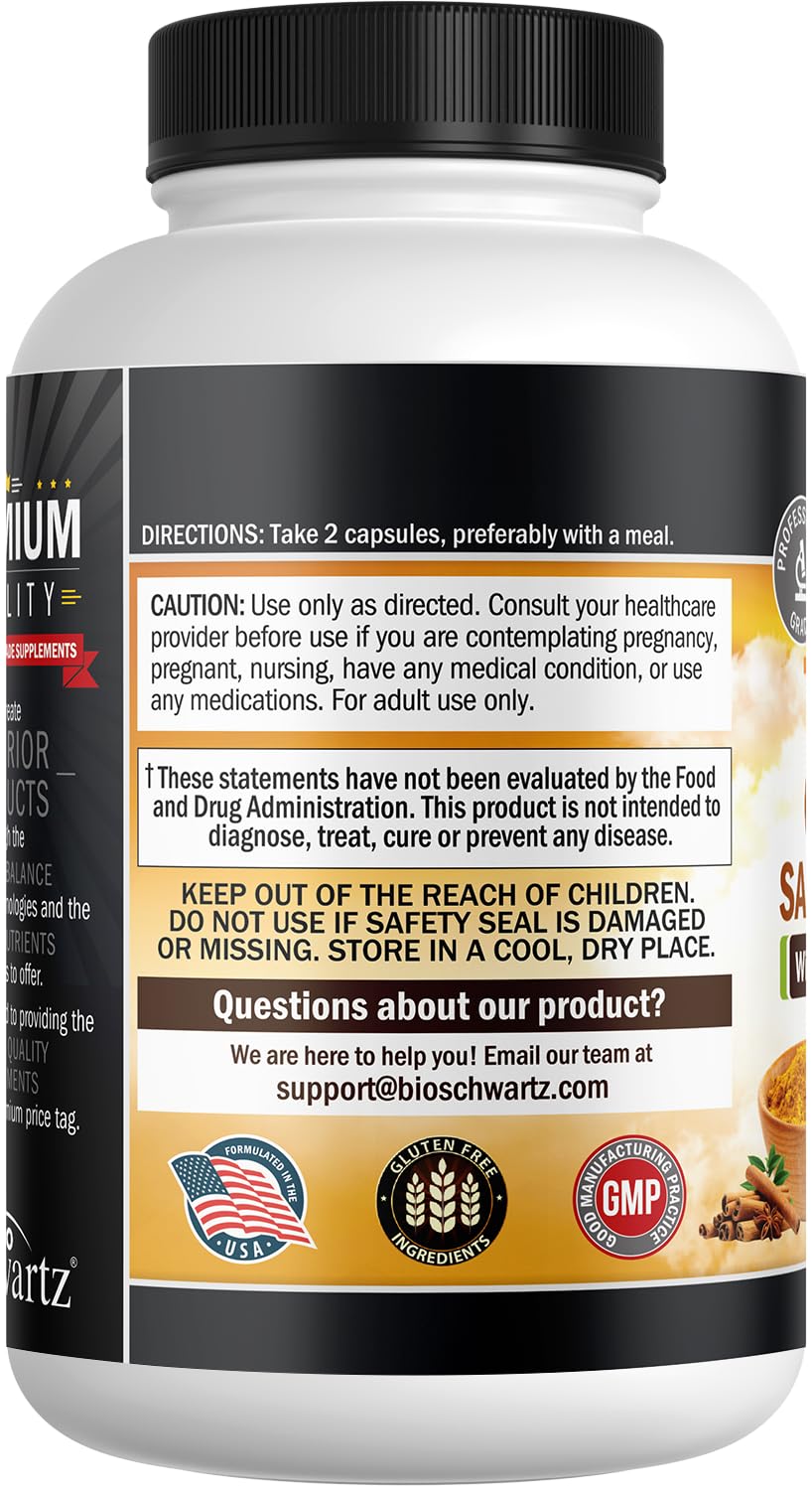 Two turmeric capsules on a wooden surface