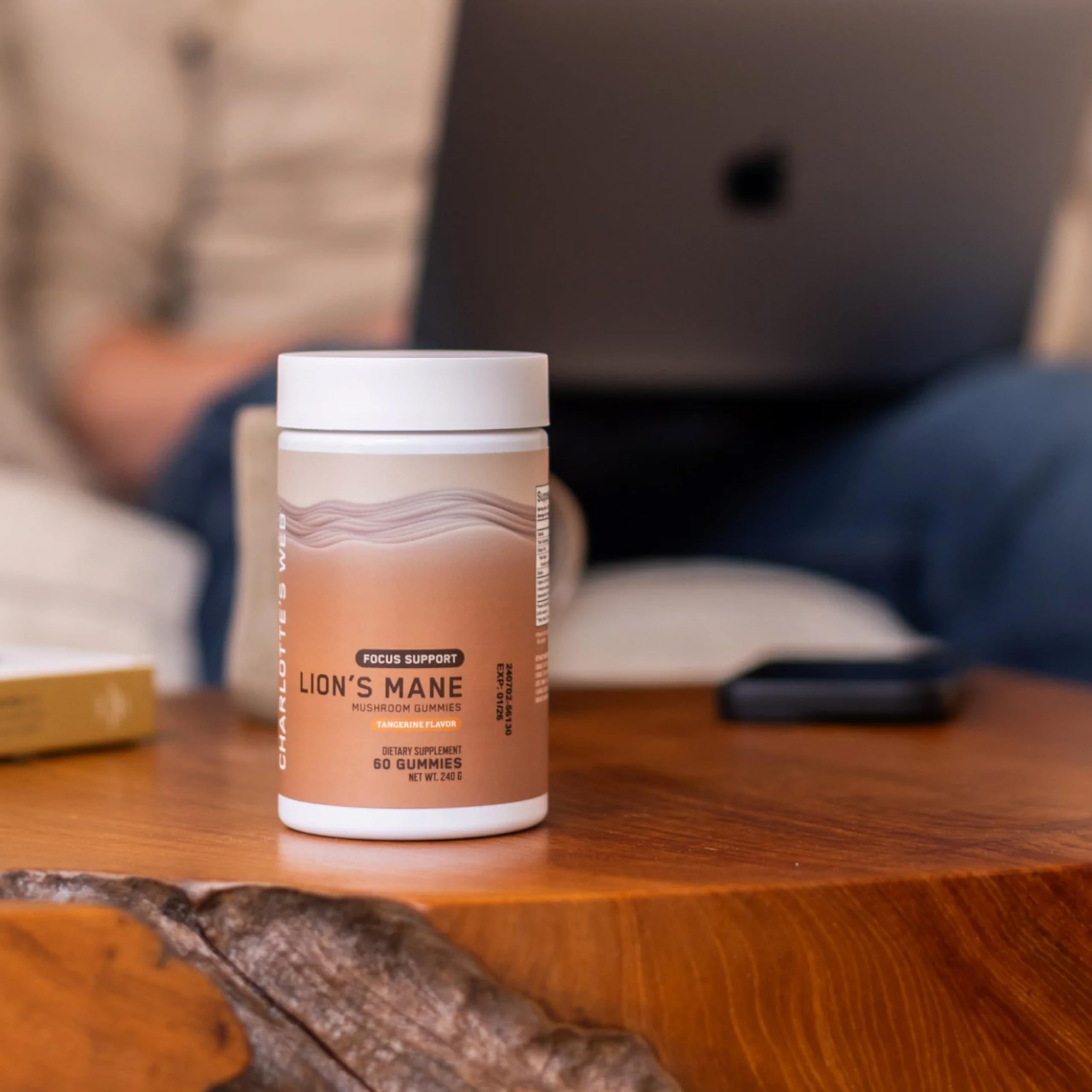 Adult taking Lion’s Mane gummies for focus and energy
