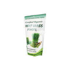 Measuring scoop of organic wheatgrass powder being added to a smoothie