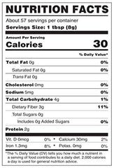 Wheatgrass powder beside a glass of smoothie and greens