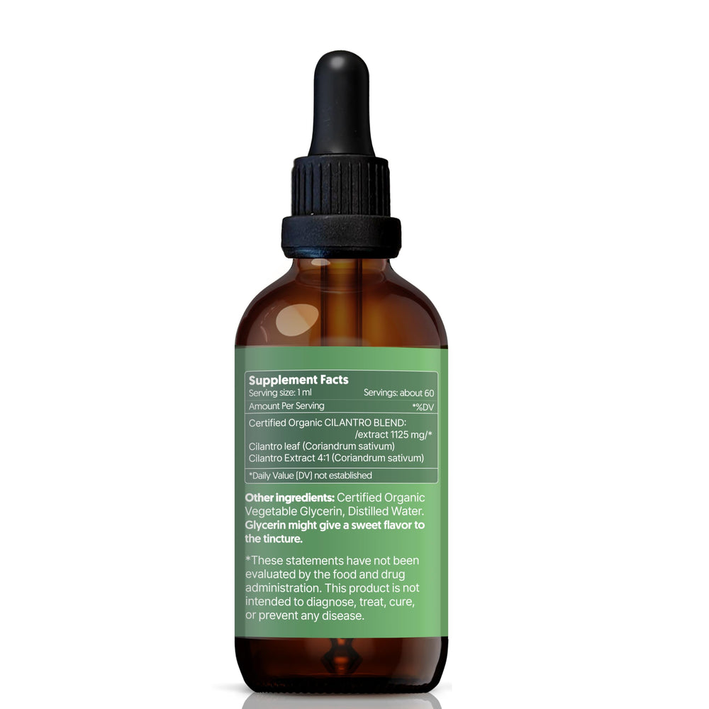 Dropper releasing cilantro tincture into a glass of water