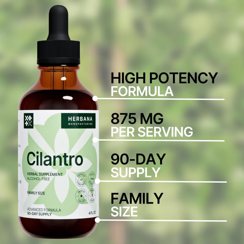 Dropper dispensing cilantro tincture into a glass of water