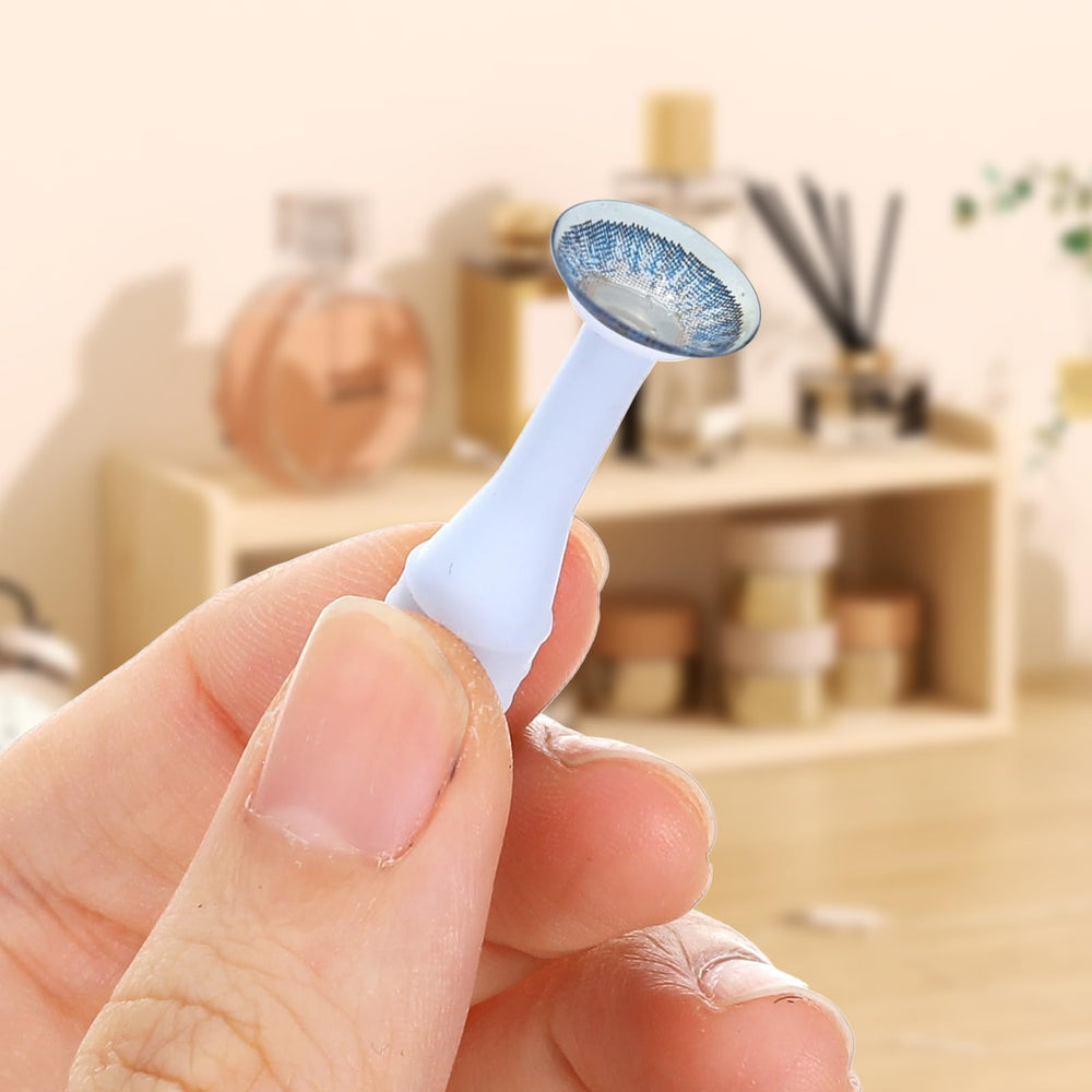 Close-up of colorful soft contact lens remover tools in white, pink, blue, orange, and green