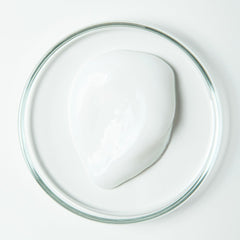 Close-up of toothpaste ingredients: aloe vera, organic peppermint, green tea extract, fluoride