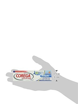 Applying Corega Ultra Adhesive Cream Fresh 40g on a denture