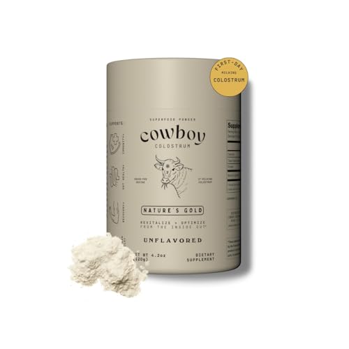 Cowboy Colostrum Powder bottle with scoop on white background