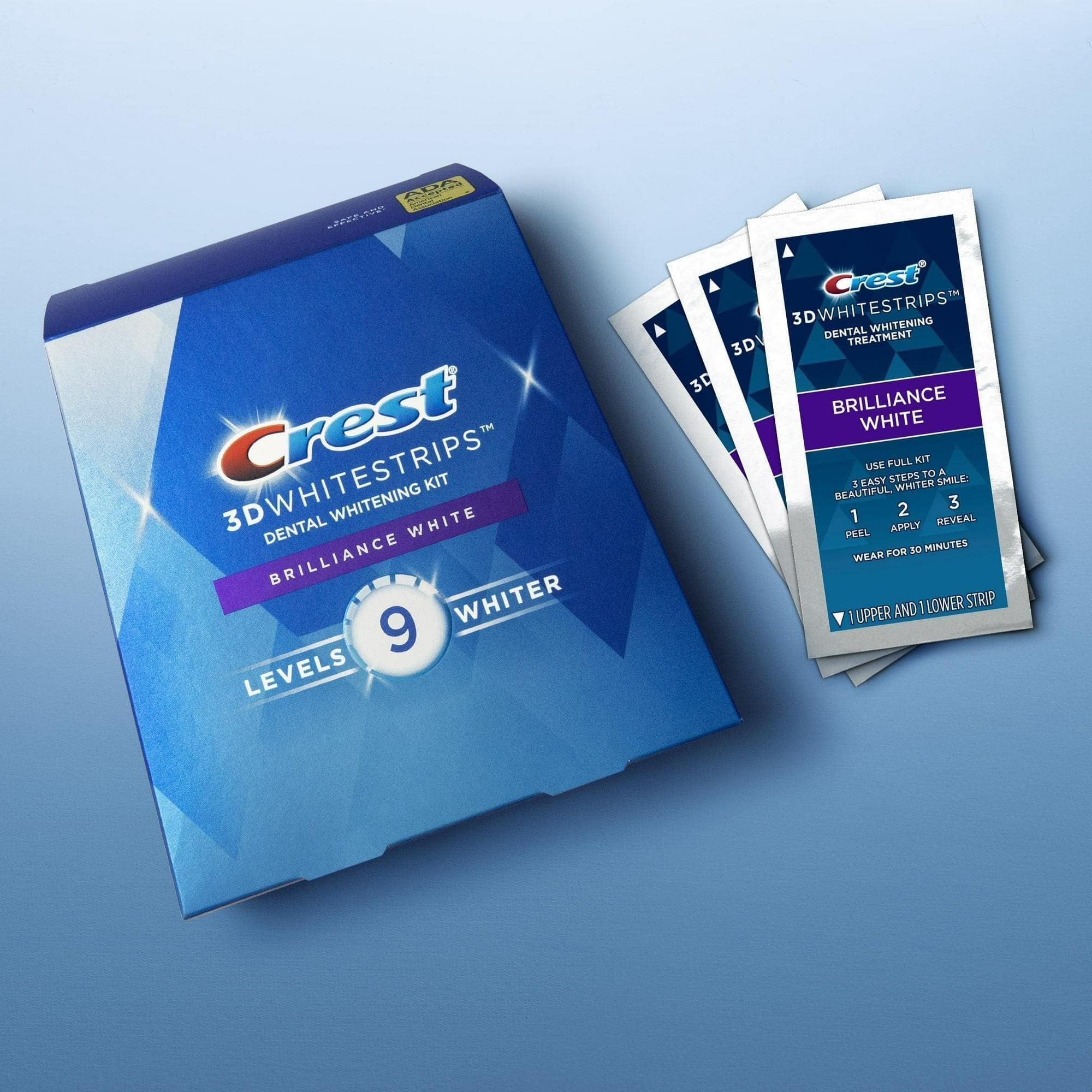 User applying Crest 3D Whitestrips Brilliance White upper and lower strips