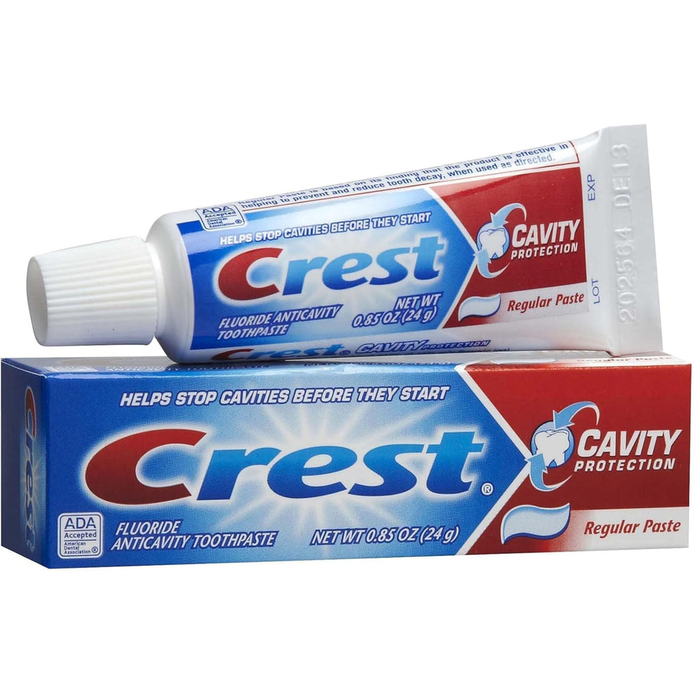 Toothbrush with Crest toothpaste mint flavor being applied