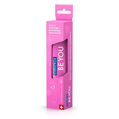 Watermelon flavored toothpaste swirls on white background with mint hints