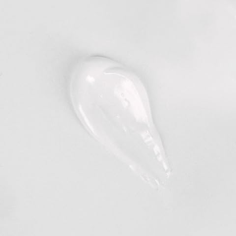 Toothpaste being brushed on a toothbrush with low abrasiveness