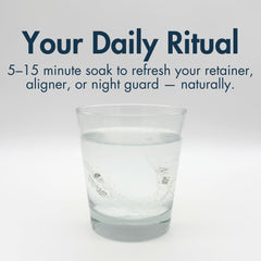 Dentures and mouthguards soaking during cleaning with The Daily Refresher