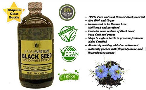 Dark amber oil in bottle being poured