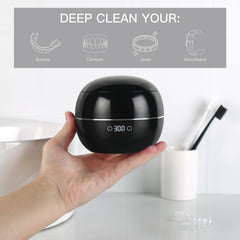Side view of the black dental ultrasonic retainer cleaner
