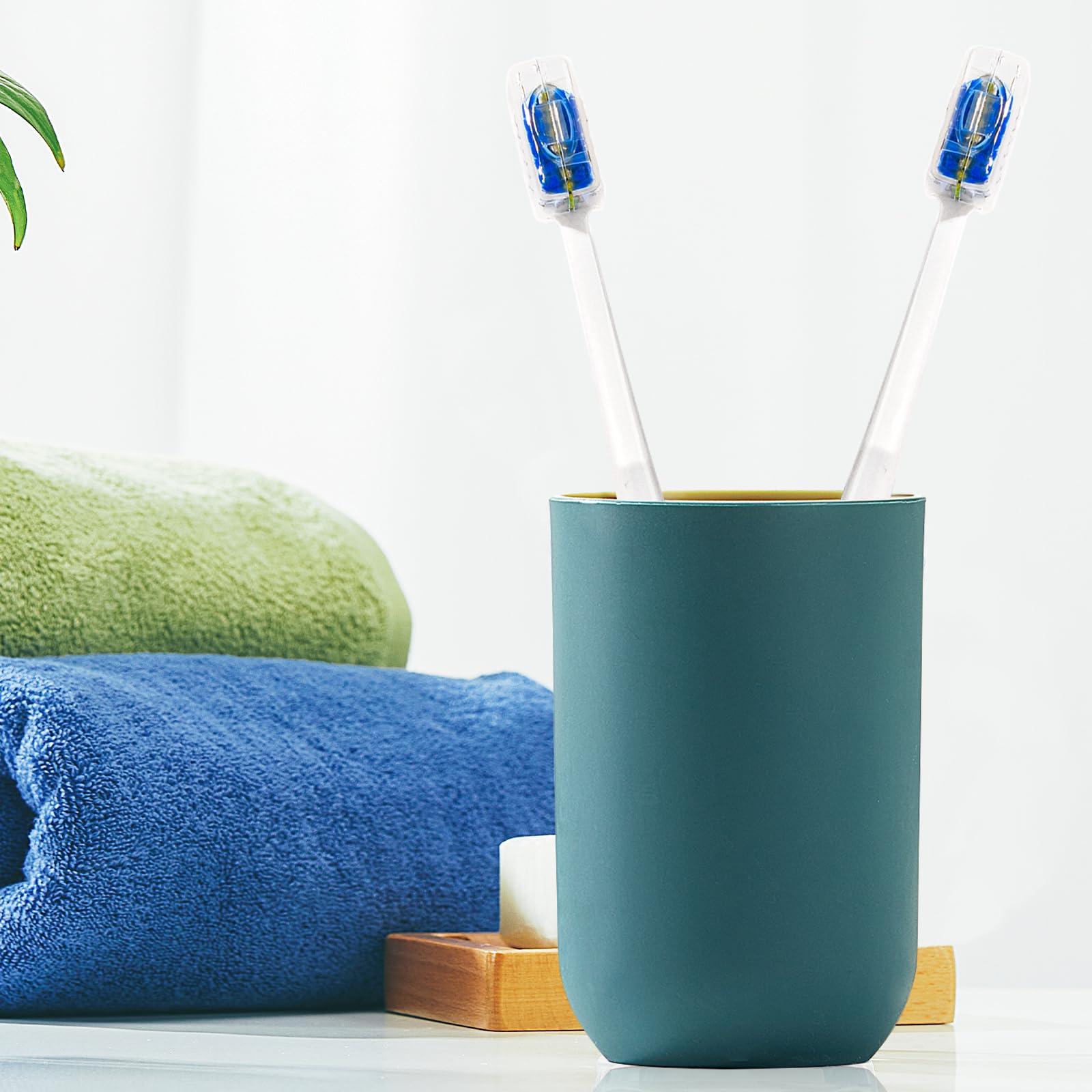Four toothbrushes with protective covers in a 4 pack