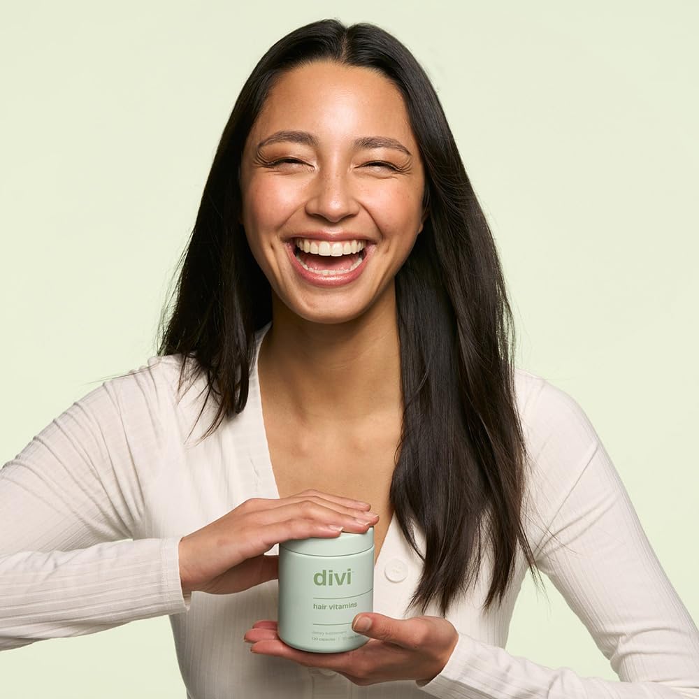 Divi Hair Vitamins bottle with glass of water