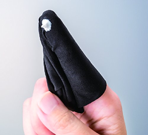 Applying a small amount of cream to eyeglass frames with a fingertip