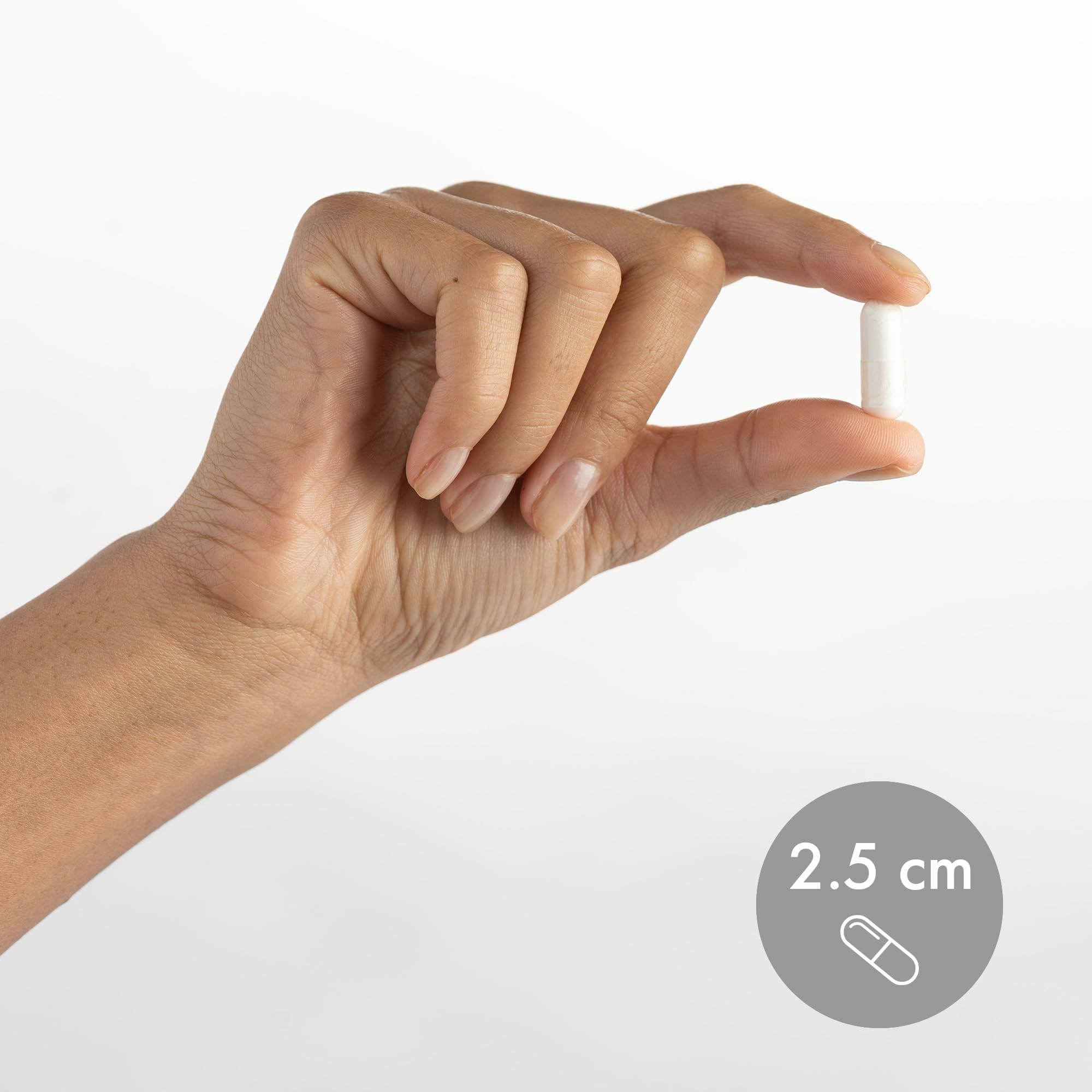 Hand holding easy-to-swallow magnesium capsules