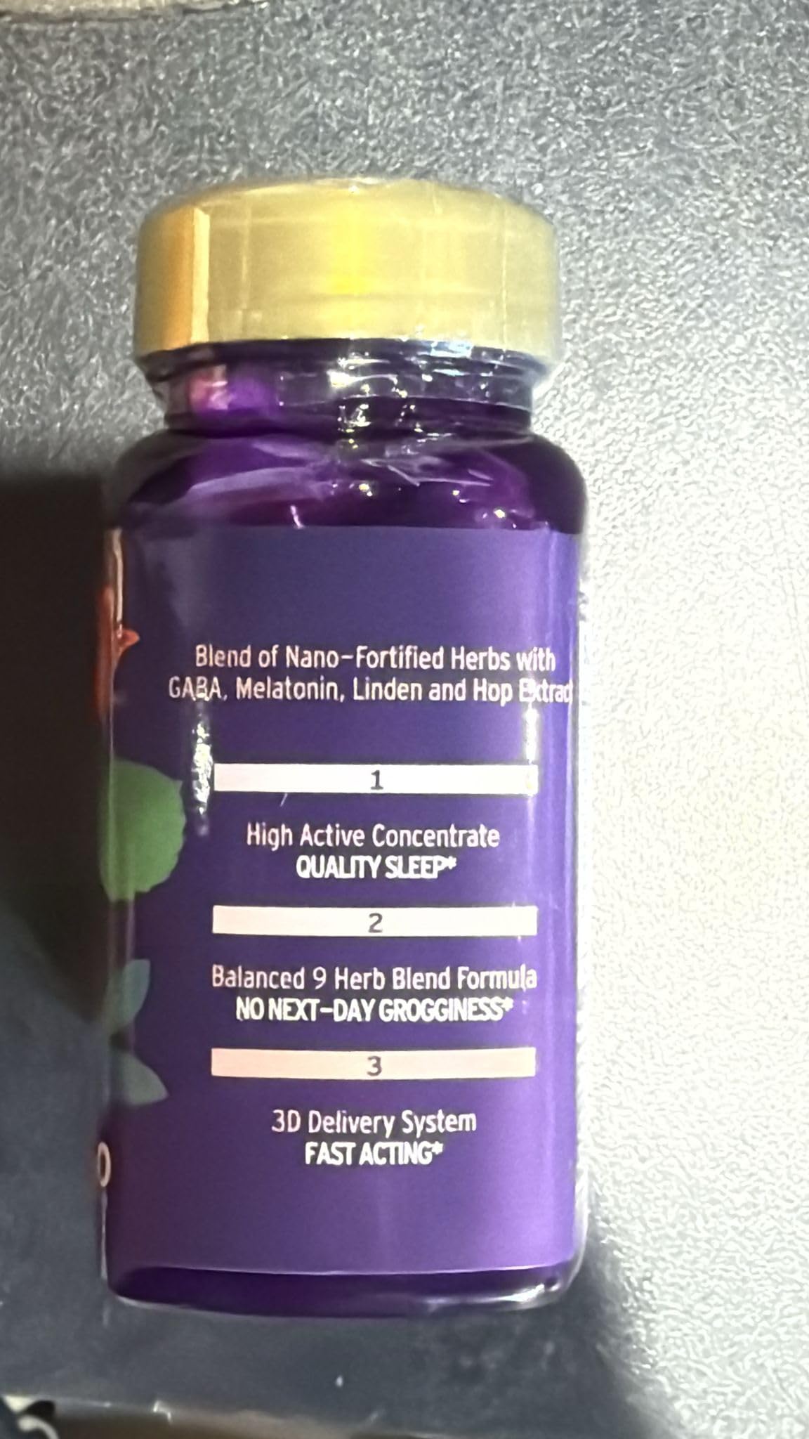 Dream Spell capsule beside herbal ingredients passionflower lemon balm hibiscus