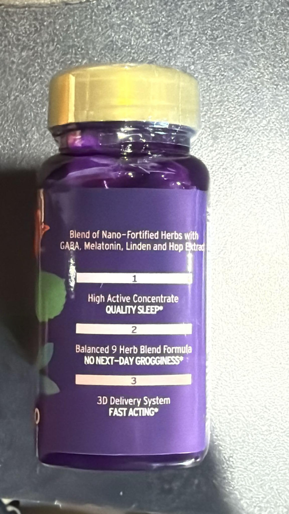 Dream Spell capsule beside herbal ingredients passionflower lemon balm hibiscus