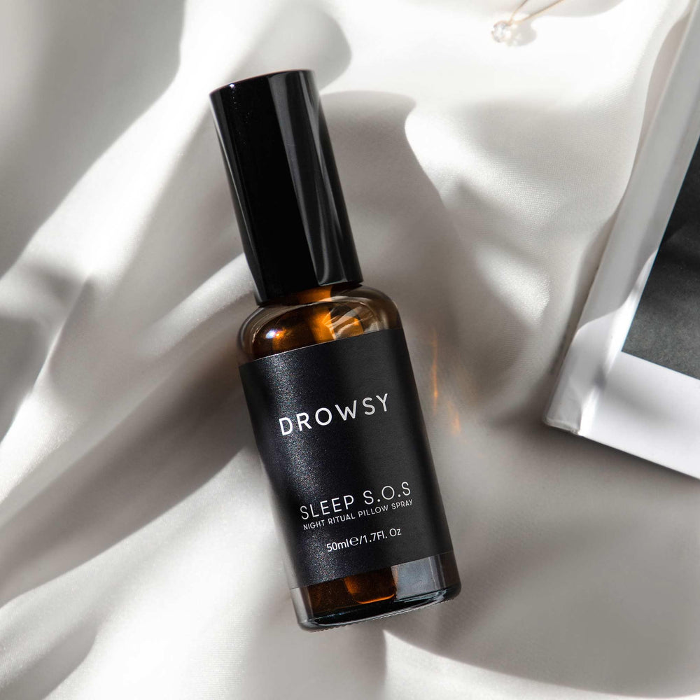 Nightstand with DROWSY SOS Sleep Pillow Spray by bedside