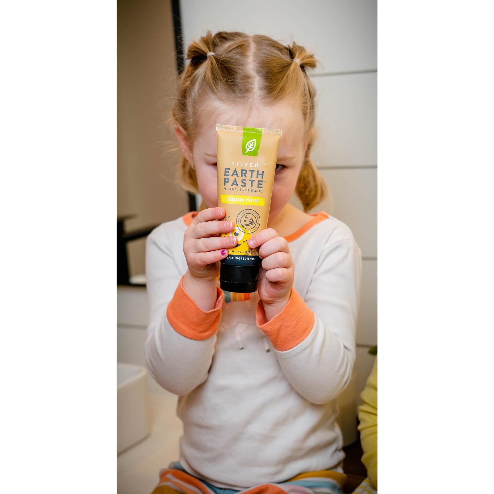 Natural ingredients laid out: bentonite clay, sea salt, essential oils