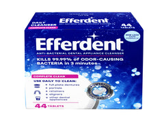 Close-up of Efferdent Complete Clean tablets dissolving in warm water