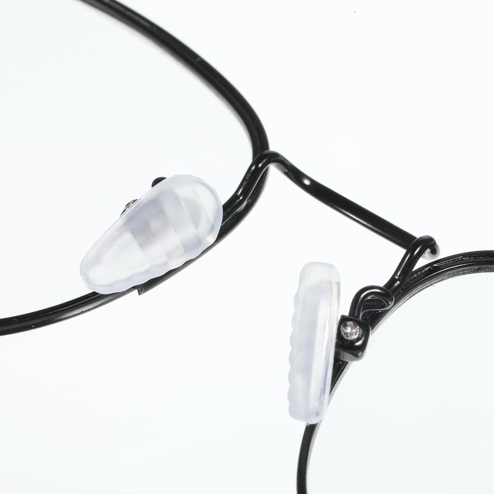 Nose pads being installed on an eyeglass frame