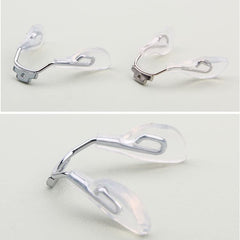 Close-up of eyeglasses nose pad area with replacement pads