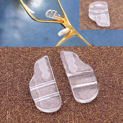 Two white semi-soft silicone nose pads for Tag Heuer eyewear, front view