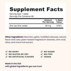 Dissolving zinc lozenges on tongue in blueberry flavor